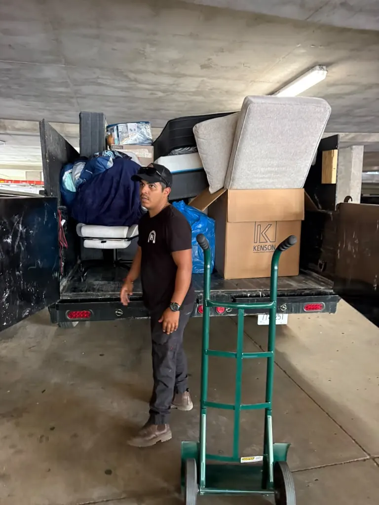 José from Dumpster Services loading furniture into the trailer