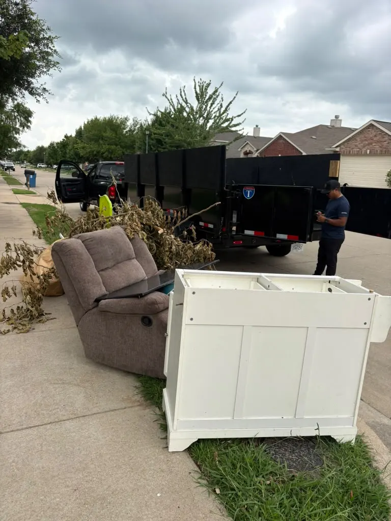 Furniture and debris picked up curbside at a house