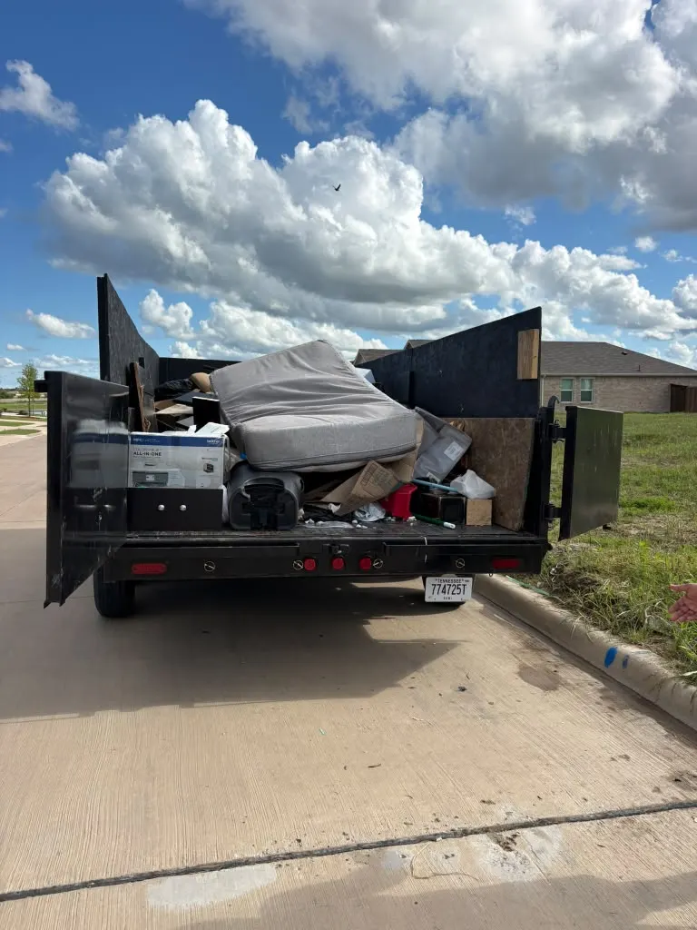 Household junk loaded into the dumpster trailer