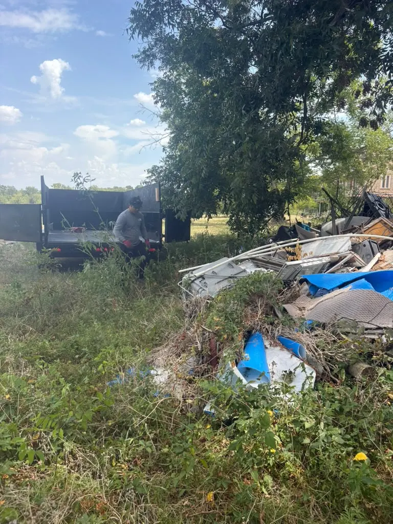 Backyard debris being cleared into the trailer